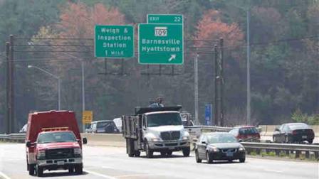 Northbound vehicles drive on Interstate 270 past the exit to Hyattstown, Md. Friday, March 23, 2012. Maryland State Police say an armored truck lost some cash on I-270 near Hyattstown. (AP Photo/Manuel Balce Ceneta)