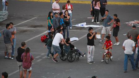People gather outside a shopping mall after an earthquake was felt in Talca, Chile, Sunday, March 25, 2012. A magnitude-7.2 earthquake has struck just off the coast of central Chile, prompting an emergency evacuation order for people living near the ocean in case it spawns a tsunami. (AP Photo/Fabian Suazo)