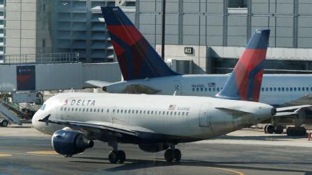 A Delta Airlines plane taxis past a gate at Logan Airport in Boston Tuesday, Jan. 24, 2012. Delta Air Lines said Wednesday, Jan. 25, 2012, it earned $425 million in the fourth-quarter as it raised prices in the critical holiday season and the airline reduced flying to keep costs low. (AP Photo/Charles Krupa)
