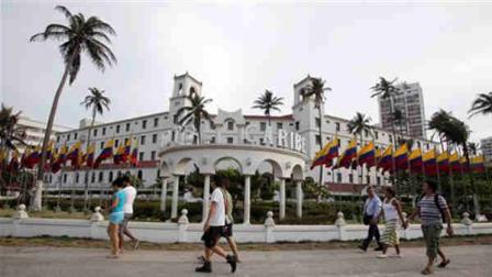 People walk past Hotel El Caribe in Cartagena, Colombia, Saturday April 14, 2012. The Secret Service sent home some of its agents for misconduct that occurred at the hotel before President Barack Obamas arrival on Friday for the Summit of the Americas. (AP Photo/Fernando Vergara)