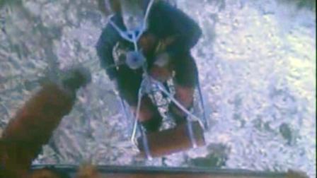 This framegrab image provided by the U.S. Coast Guard shows one of three crew members from the yacht Low Speed Chase being rescued from the Farallon Islands west of San Francisco Saturday April 14, 2012 by the U.S. Coast Guard. The sail boat carrying eight crew members ran aground during a race off San Francisco Saturday, killing one person and leaving four others missing, the Coast Guard said. (AP Photo/US Coast Guard)