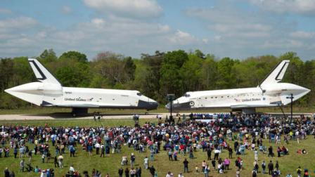In this photo provided by the Smithsonian Institution via NASA, space shuttles Enterprise, left, and Discovery meet nose-to-nose at the beginning of a transfer ceremony at the Smithsonians Steven F. Udvar-Hazy Center, Thursday, April 19, 2012, in Chantilly, Va. Space shuttle Discovery will take the place of Enterprise at the center to commemorate past achievements in space and retire as an artifact representing the 30-year shuttle program.