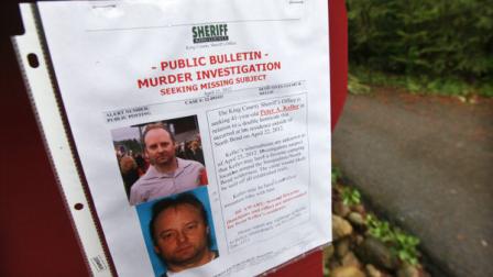 A sign warning of murder suspect Peter Alex Keller is seen at a trailhead several miles from where a gun-toting survivalist is suspected of killing his wife and daughter several days earlier Friday, April 27, 2012, in North Bend, Wash. Keller may be holed up in a self-made fort not far from where Seattles outer suburbs give way to the vast recreational playground of Cascade Mountains. Police expect more people to hit the nearby trails this weekend, and deputies are warning them to steer clear of Keller if they think they see him. (AP Photo/Elaine Thompson)