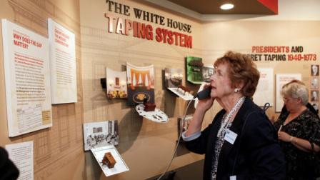 Mary Fuhrman, with the League of Women Voters of North Orange County, listens to a presentation of The Gap, the infamous 18 1/2-minute gap in a White House tape recording, as part of The Watergate Gallery exhibit on the history of the Watergate scandal leading to the resignation of former President Richard Nixon, at the Richard Nixon Presidential Library in Yorba Linda, Calif. Thursday, March 31, 2011. (AP Photo/Damian Dovarganes)