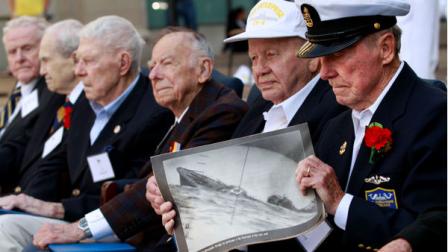 WWII Battle of Midway veteran Henry Kudzik, 87, of Bethlehem, Pa., right, holds a photograph of a sinking destroyer, next to fellow veterans including Howard Snell, of Kingman, Ariz., during a Battle of Midway 70th Commemoration ceremony at the U.S. Navy Memorial in Washington, Monday, June 4, 2012. (AP Photo/Jacquelyn Martin)