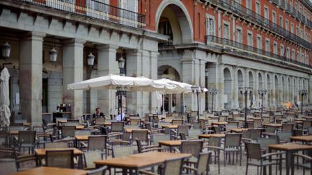 Two mens are the only customers of an almost empty terrace in the Plaza Mayor, in Madrid, Monday, April 30, 2012. Spains National Statistics Institute announce on Monday that Spain is officially back in recession as the countrys economy shrank 0.3 percent in the first quarter compared to the previous three months. This is Spains second recession in three years. Spains economic problems have become the focus of Europes debt crisis as investors worry over Spains ability to push through austerity measures and reforms at a time of recession and an unemployment rate hitting 24 per cent - or 50 per cent for those aged under 25. Late last week, S&P downgraded the countrys credit rating by two notches from A to BBB+, citing a worsening budget deficit, worries over the banking system, and poor economic prospects.(AP Photo/Daniel Ochoa de Olza)