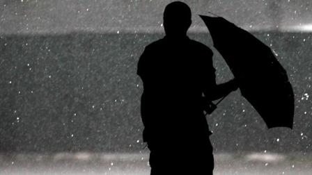 Tampa Tribune sports writer Bill Ward is silhouetted as he arrives in a heavy rain at Raymond James Stadium for the USA national team soccer practice Thursday, June 7, 2012, in Tampa, Fla. The practice was moved to another stadium due to the heavy rain. (AP Photo/Chris OMeara)