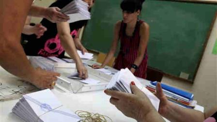 Election officials count ballots during parliamentary elections at a polling station, in Athens, Sunday, June 17, 2012. Greeks are voting Sunday for the second time in six weeks in what is arguably their countrys most critical election in 40 years. (AP Photo/Petros Giannakouris)