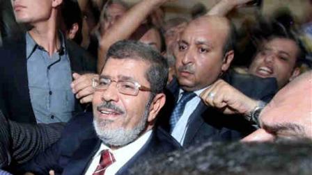 Mohammed Morsi and his supporters celebrate his apparent victory in the Egyptian presidential election at his campaign headquarters in Cairo, Egypt, Monday, June 18, 2012. The Muslim Brotherhood declared early Monday that its candidate, Mohammed Morsi, won Egypts presidential election, which would be the first victory of an Islamist as head of state in the stunning wave of protests demanding democracy that swept the Middle East the past year. (AP Photo/Ahmed Gomaa)