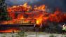 In this Saturday, June 23, 2012 photo provided by Darrell Spangler, a firefighter works the scene of a home being consumed by flames in Estes Park, Colo. As many as 21 structures were destroyed by the fire on Saturday. Eight separate wildfires are burning across Colorado, which is seeing record-breaking heat. (AP Photo/Darrell Spangler) MANDATORY CREDIT 
