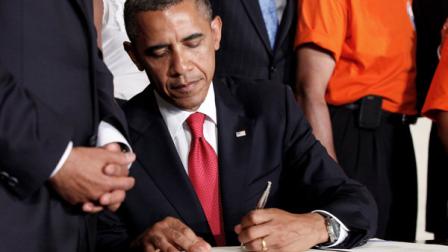President Barack Obama signs the Surface Transportation Bill, HR 4348, during a ceremony in the East Room of the White House in Washington, Friday, July 6, 2012. The bill maintains jobs on transportation projects and prevents interest rate increases on new loans to millions of college students. (AP Photo/Pablo Martinez Monsivais)