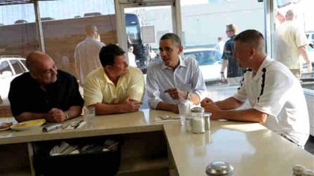 President Barack Obama talks with patrons of Anns Place in Akron, Ohio, Friday, July 6, 2012. From left are, Jim DiFalco, a Goodyear worker from Tallmadge, Ohio; Rick Nixon, a Goodyear worker from Norton, Ohio; the president; and Keith Ross, a Goodyear worker from Norton, Ohio. Obama is on a two-day bus trip through Ohio and Pennsylvania. (AP Photo/Susan Walsh) Rick works in the mix center at the Goodyear plant in Akron. Has worked for Goodyear for almost 20 years and is the Political Coordinator for the UAW Local 2L in Akron. Jim was first hired at Goodyear in 1980. He was laid off in 1986, then re-hired in 1992 and has worked there ever since. His father and grandmother both worked for Goodyear. Keith has worked at Goodyear for 14 years where he makes NASCAR racing tires.