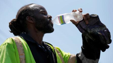 A paving crew member takes a drink of water in the afternoon heat, Friday, July 6, 2012, in Philadelphia. The National Weather Service said the record-breaking heat that has baked the nations midsection for several days was slowly moving into the mid-Atlantic states and Northeast. Excessive-heat warnings remained in place Friday for all of Iowa, Indiana and Illinois as well as much of Wisconsin, Michigan, Missouri, Ohio and Kentucky. (AP Photo/Matt Rourke)
