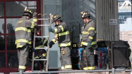 Firefighters inspect Pier 17 in New York on Saturday, July 14, 2012 after a three-alarm fire at the South Street Seaport. Fire officials said there were no injuries. (AP Photo/Mary Altaffer)