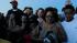 People hold hands as they pray during a vigil,...