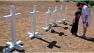 Cheryl Almendarez, right, grieves with Dallas Burke, 6, both from Aurora, Colo., next to crosses set up by Greg Zanis for the 12 victims across the street from the Century 16 movie theater in Aurora, Colo., on Sunday, July 22, 2012. Twelve people were killed and dozens injured in a shooting attack early Friday at the packed theater during a showing of the Batman movie, The Dark Knight Rises. Police have identified the suspected shooter as James Holmes, 24. In 1999, Zanis, of Aurora, Ill., placed 15 crosses near Columbine High School to commemorate the victims. (AP Photo/Alex Brandon) 