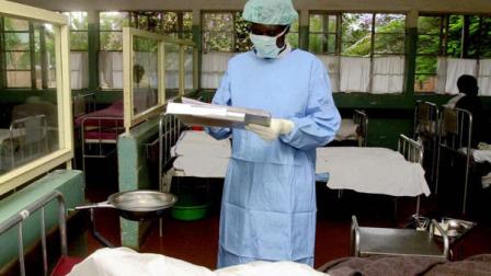 A Medical Officer at Lacor hospital Gulu, Uganda, 352 kilometers (219 miles) from the Uganda capital, Kampala, examines a patient who is suspected to have Ebola, Wednesday, Oct.18, 2000. A team of health experts identified the disease ravaging the northern district of Gulu in Uganda as Ebola. The disease has claimed at least 39 lives in Gulu and another 55 people are suspected of having the incurable disease, officials said Wednesday.. (AP Photo/Sayyid Azim)