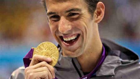 United States Michael Phelps displays his gold medal for the mens 100-meter butterfly swimming final at the Aquatics Centre in the Olympic Park during the 2012 Summer Olympics in London, Friday, Aug. 3, 2012. (AP Photo/Matt Slocum)