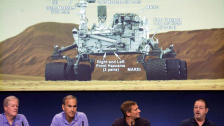 Scientists comment on the seven cameras aboard the Curiosity Mars Rover, background, during a media briefing of the Mars Science Laboratory, science overview news briefing at NASAs Jet Propulsion Laboratory, in Pasadena, Calif., Thursday, Aug. 2, 2012. From left: Michael Meyer, scientist, Mars Exploration Program lead, John Grotzinger, MSL project scientist, California Institute of Technology, Don Hassler, principal investigator, Radiation Assessment Detector on MSL, Michael Malin, principal investigator, Mars Descent Imager on MSL. Curiosity is scheduled to land on Mars Sunday night. (AP Photo/Damian Dovarganes)