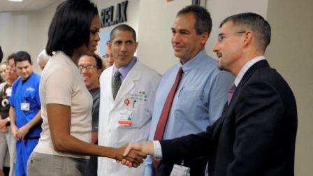 First lady Michelle Obama shakes hands with Dr. James Denton, a first responder to the Aurora theater shooting, at The Medical Center of Aurora on Saturday Aug. 11, 2012, in Aurora, Colo. (AP Photo/Jack Dempsey)