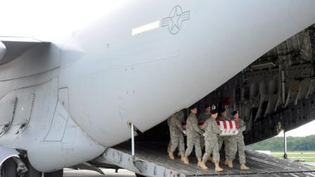 An Army carry team moves a transfer case containing the remains of Spc. James A. Justice Sunday, Aug. 19, 2012 at Dover Air Force Base, Del. According to the Department of Defense, Justice, 21, of Grover, N.C., died Aug. 17, 2012 at Landstuhl Regional Medical Center in Germany from injuries sustained from enemy small-arms fire Aug. 14, 2012 in Wardak province, Afghanistan. (AP Photo/Steve Ruark)