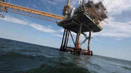 FILE - In this Tuesday, April 27, 2010 file photo, An oil rig is seen in the Gulf of Mexico near the Chandeleur Islands, off the Southeastern tip of Louisiana. Energy companies have reoccupied nearly 400 of the production platforms in the Gulf of Mexico that were abandoned in advance of Hurricane Isaac, though oil production remains almost entirely shut down. Oil and gas workers began retaking the offshore sites Friday and federal officials on Saturday, Sept. 1, 2012 say that 377 of the 596 productions platforms have some staffing on them, up from just 97. (AP Photo/Gerald Herbert, File)