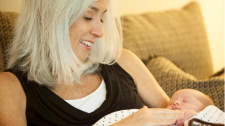Cindy Reutzel holds her granddaughter Elle Cynthia Jordan on Wednesday, Sept. 5, 2012 in Naperville, Ill. Reutzel gave birth to her granddaughter on Thursday, Aug. 30, 2012 after acting as a surrogate for her own daughter Emily Jordan, who had undergone a radical hysterectomy. (AP Photo/Sitthixay Ditthavong)