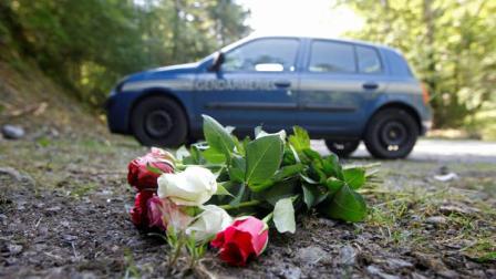 Flowers are seen on the crime scene where four people have been shot to death in a British-registered car, in a forest in the Alps, near Chevaline, French Alps, Saturday, Sept. 8, 2012. The case took on international ramifications, with links that tied the slain family to Britain, Iraq and Sweden. (AP Photo/Laurent Cipriani)