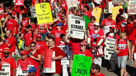 Striking Chicago school teachers march after a rally Saturday, Sept. 15, 2012 in Chicago. Thousands of striking Chicago public school teachers and their allies packed a city park Saturday in a boisterous show of force as union leaders and the district tried to work out the details of an agreement that could end a week-long walkout.(AP Photo/Sitthixay Ditthavong)