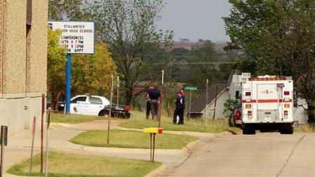 A fire-rescue truck and a police car are parked outside Stillwater Junior High School in Stillwater, Okla., Wednesday, Sept. 26, 2012. A 13-year-old student shot and killed himself in a hallway at an Oklahoma junior high school before classes began Wednesday, police said, terrifying teenagers who feared a gunman was on the loose. (AP Photo/Sue Ogrocki)