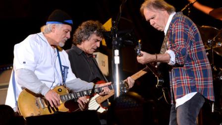 Musician Neil Young, right, performs with his band Crazy Horse including Frank Sampedro, left, and Ralph Molina, at the Global Citizen Festival in Central Park on Saturday Sept. 29, 2012 in New York. (Photo by Evan Agostini/Invision/AP)