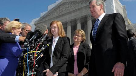 Abigail Fisher, the Texan involved in the University of Texas affirmative action case, accompanied by her attorney Bert Rein, right, talks to reporters outside the Supreme Court in Washington, Wednesday, Oct. 10, 2012. The Supreme Court is taking up a challenge to a University of Texas program that considers race in some college admissions. The case could produce new limits on affirmative action at universities, or roll it back entirely. The University of Texas at Austin President Bill Powers is at right.(AP Photo/Susan Walsh)