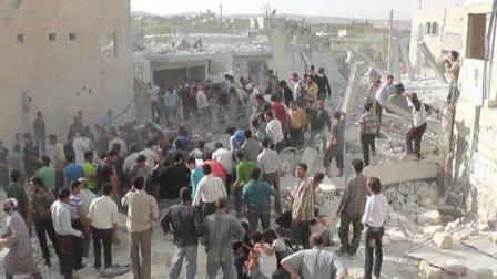 In this Wednesday, Oct. 17, 2012 photo, citizen journalism image provided by Edlib News Network, ENN, which has been authenticated based on its contents and other AP reporting, Syrian citizens gather to rescue people from under the rubble of a building that was destroyed from a Syrian force airstrike, at Kfar Nebel town, in Idlib province, northern Syria. (AP Photo/Idlib News Network ENN)