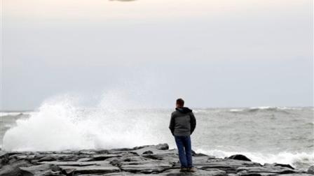 Resident Brian Dougherty looks at the waves from the beach in Ocean City, Md., as Hurricane Sandy approaches the Atlantic Coast, on Saturday, Oct. 27, 2012. ( AP Photo/Jose Luis Magana)