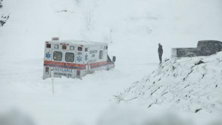An ambulance is stuck in over a foot of snow off of Highway 33 West, near Belington, W.Va. on Tuesday, Oct. 30, 2012, in Belington, W.Va. Superstorm Sandy buried parts of West Virginia under more than a foot of snow on Tuesday, cutting power to at least 264,000 customers and closing dozens of roads. At least one death was reported. The storm not only hit higher elevations hard as predicted, communities in lower elevations got much more than the dusting of snow forecasters had first thought from a dangerous system that also brought significant rainfall, high wind gusts and small-stream flooding. (AP Photo/Robert Ray)