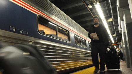 Passengers board an Albany-bound Amtrak train from Penn Station, Sunday, Oct. 28, 2012, in New York. (AP Photo/Louis Lanzano)