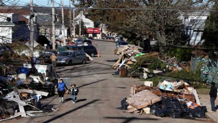 arbage lies piled on the street in the New Dorp neighborhood of Staten Island, N.Y., Sunday, Nov. 4, 2012, in the aftermath of Superstorm Sandy. (AP Photo/Seth Wenig)