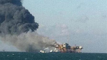 In this image released by a oil field worker and obtained by the Associated Press, a fire burns on a Gulf oil platform Friday, Nov. 16, 2012, after an explosion on the rig, in the Gulf of Mexico off the Louisiana coast. An explosion and fire ripped through a Gulf oil platform Friday as workers used a cutting torch, sending at least four people to a hospital with burns and leaving two missing in waters off Louisiana. (AP Photo)