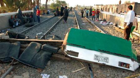 Egyptians block the tracks with debris from the crash and railroad ties at the scene of a train crash that killed at least 49 people, most of them children between 4 and 6 years old near Assiut in southern Egypt, Saturday, Nov. 17, 2012. Egyptian security officials say grieving families in the central province of Assiut have cut off roads and denied the prime minister access to the scene of a train accident that killed at least 49 kindergartners. (AP Photo)