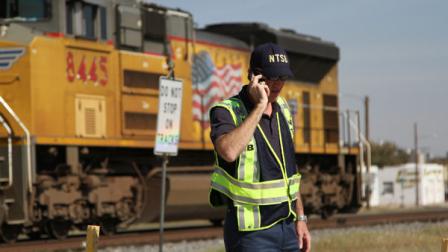 A railroad investigator talks on the phone at the scene of an accident where four veterans were killed and 16 other people were injured when a train slammed into a parade float carrying the returning heroes to a banquet last Thursday in Midland, Texas on Saturday, Nov. 17, 2012. Federal investigators were trying to determine whether the two-float parade had been given enough warning to clear the tracks. (AP Photo/Juan Carlos Llorca)
