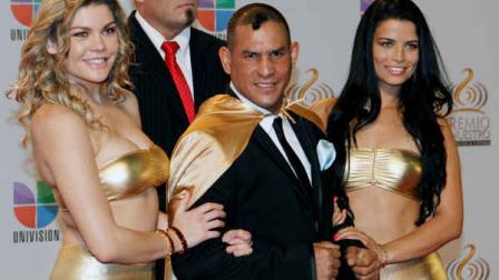 FILE - In this Feb. 16, 2012 file photo former boxing champion Hector Macho Camacho, front center, poses for photographers at his arrival to the Premio Lo Nuestro Music Awards in Miami. Police in Puerto Rico say Camacho has been shot and critically wounded Tuesday, Nov. 20, 2012. (AP Photo/Alan Diaz, File)
