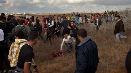 Hamas police officers prevent Palestinians from approaching the Israeli Gaza border fence in east of Khan Younis, southern Gaza Strip, Friday, Nov. 23, 2012. Hundreds of Gaza crowds surged toward Israels border fence with the Hamas-ruled territory, in a no-go-zone that has been kept by Israel for years to prevent infiltrators. The crowd, many returning to their farm land, were testing new agreements mediated by the Egyptians between Hamas and Israel that led to a cease-fire after eight days of cross-bordering fighting. One Palestinian was killed and 19 injured. (AP Photo/Bernat Armangue)