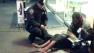 This photo provided by Jennifer Foster shows New York City Police Officer Larry DePrimo presenting a barefoot homeless man in New Yorks Times Square with boots Nov. 14, 2012 .  (AP Photo/Jennifer Foster)