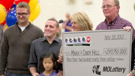 Mark and Cindy Hill hold a Powerball check with their three of their four children, Jarod, left, Cody and six-year-old Jaiden in Dearborn, Mo., Friday, Nov. 30, 2012. (AP Photo/Orlin Wagner)
