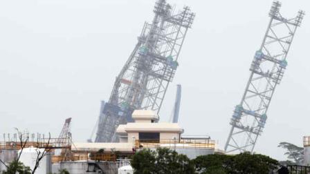 A backup rig is seen tilted to one side off a shipyard on Monday Dec. 3, 2012 in Singapore. The ministry of manpower reported that about 90 workers were sent to hospitals after a jackup rig at a shipyard in Singapore tilted to one side.(AP Photo/Wong Maye-E)