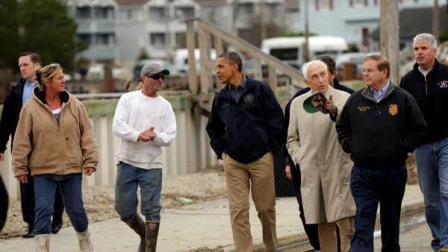 President Barack Obama, center, talks with a local resident as he tours a neighborhood effected by superstorm Sandy, Wednesday, Oct. 31, 2012 in Brigantine, N.J. Walking with Obama are Sen. Frank Lautenberg, D-N.J., and Sen. Bob Menendez, D-N.J., far right. (AP Photo/Pablo Martinez Monsivais)
