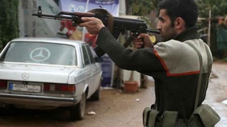 A Sunni gunman fires his weapon during clashes that erupted between pro and anti-Syrian regime gunmen in the northern port city of Tripoli, Lebanon, Wednesday, Dec. 5, 2012. Gunmen loyal to opposite sides in neighboring Syrias civil war battled in the streets of northern Lebanon at a time of deep uncertainty in Syria, with rebels closing in on President Bashar Assads seat of power in Damascus. (AP Photo/Hussein Malla)