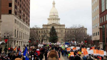 Thousands of supporter march to the State Capitol grounds in Lansing, Mich., Tuesday, Dec. 11, 2012. The crowd is protesting right-to-work legislation that was passed by the state legislature last week. (AP Photo/Carlos Osorio)