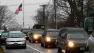 A hearse and family limousines for six-year-old shooting victim Jack Pinto rolls past a flag at half staff as the funeral procession heads through the historic district in Newtown, Conn., Monday, Dec. 17, 2012. A gunman opened fire on Friday at Sandy Hook Elementary School in the town, killing 26 people, including 20 children before killing himself. (AP Photo/Charles Krupa)