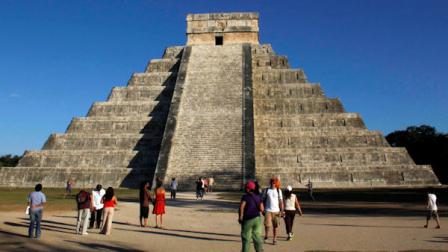 People gather in front of the Kukulkan Pyramid in Chichen Itza, Mexico, Thursday, Dec. 20, 2012. American seer Star Johnsen-Moser led a whooping, dancing, drum-beating ceremony Thursday in the heart of Mayan territory to consult several of the life-sized crystal skulls, which adherents claim were passed down by the ancient Maya. (AP Photo/Israel Leal)